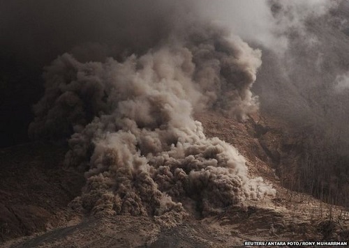 Pyroclastic flows - surges of hot ash and rock - speed down the side of Mount Sinabung