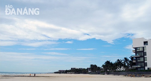 A beach in front of a resort development 