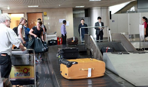 This file photo shows passengers receiving their checked luggage at Noi Bai International Airport in Ha Noi.