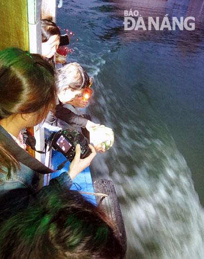   Some of Dieu’s ashes being scattered on the river