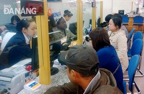 Customers at the city’s branch of the Dong A Bank 