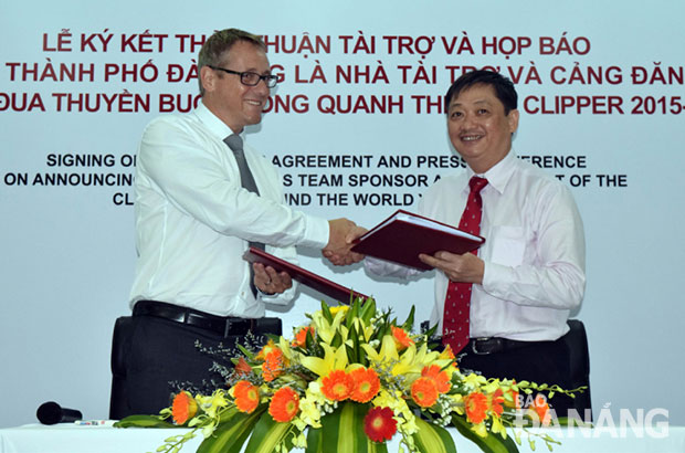 Phó Chủ tịch UBND thành phố Đặng Việt Dũng và ông David Cusworth (trái) trao văn bản ký kết.