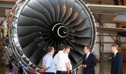 Britain's Prime Minister David Cameron (2nd R) talks with engineers next to Rolls-Royce's President of Aerospace Tony Wood (R) in front of a Rolls-Royce engine at a hangar in the Noi Bai Airport on July 29, 2015. Reuters