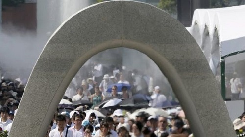 People offered prayers for victims of the atomic bombing in front of a cenotaph in Hiroshima Peace Memorial Park