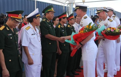 Representatives from the Viet Nam People’s Navy presenting flowers to their US guests