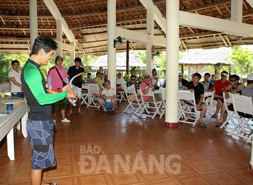   A diving instructor explains the necessary skills and how to use diving equipment