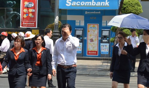 Sacombank employees are pictured in front of its main office in Ho Chi Minh City. Tuoi Tre