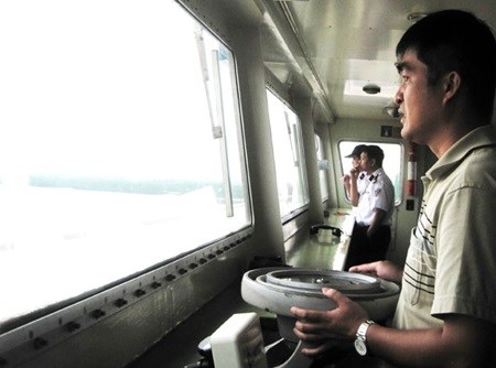 Captain Tran Minh steers the Pacific Express. 