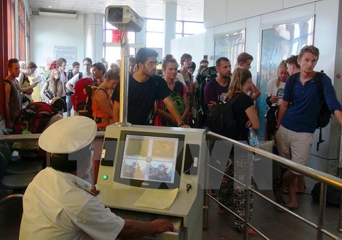 Testing body temprature of passengers crossing the Moc Bai International Border Gate in Tay Ninh province