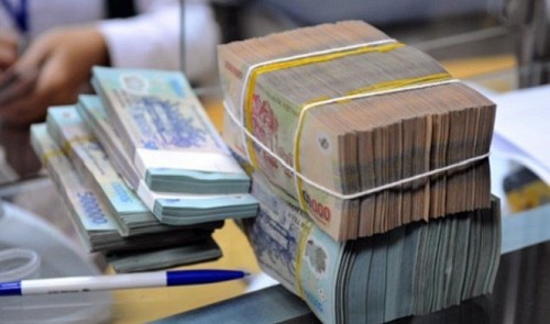 Stacks of Vietnamese dong notes are seen at a bank in Ho Chi Minh City in this photo illustration. Tuoi Tre