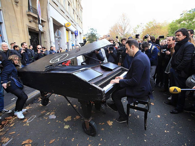 Người nghệ sĩ này đã chơi bản Imagine của John Lennon với thông điệp hòa bình.  Ảnh: AFP