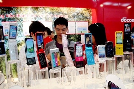 Customers shop for second-hand mobile phones at a shop in Ha Noi