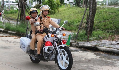 Mounted on a police motorbike, Do Tuan Dung, a young cancer patient, goes “on duty” on his 11th birthday celebration, held in Da Nang