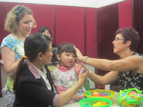 Phuong Thuy, a young girl from Cam Le District, wearing hearing aids 