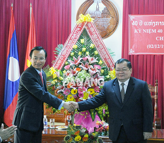 Bí thư Thành ủy Nguyễn Xuân Anh tặng hoa chúc mừng Tổng Lãnh sự Lào Khamsene Phommaseng nhân kỷ niệm 40 năm Quốc khánh nước Cộng hòa DCND Lào.  Ảnh: VIỆT DŨNG