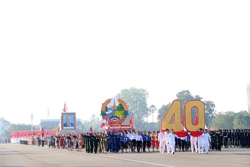 The parade begins with the procession of the 40-year symbol and the Coat of Arms of Laos