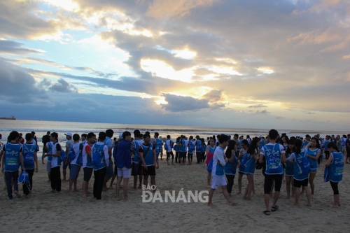 Runners gather on the beach in the early morning light