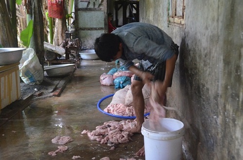  A worker at the fat-processing establishment