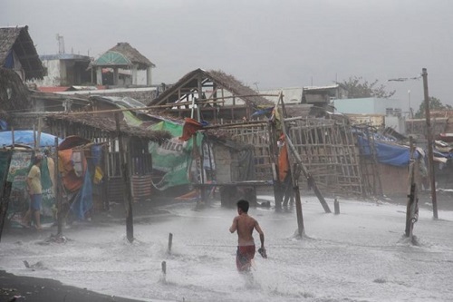 Residents are seen in a coastal area battered by strong winds and heavy rains brought by Typhoon Melor in Legazpi City, central Philippines, Dec. 15, 2015