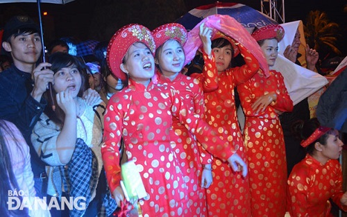   A group of young local girls in ao dais admiring the magnificent fireworks