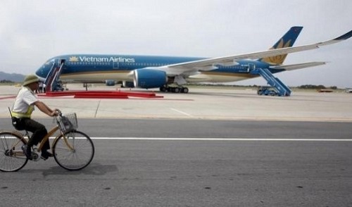 A security guard cycles near an Airbus A350-900 aircraft during its delivery ceremony at Noi Bai International Airport in Hanoi July 2, 2015. Reuters