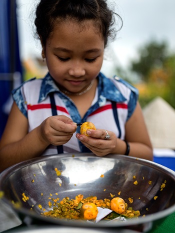  A little girl making kumquat jam