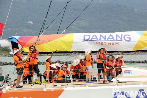 The yacht's crew members wearing conical hats before arriving at the Han River Port