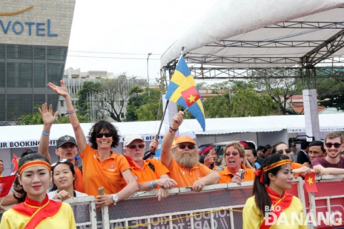 Family members, relatives and friends of Da Nang-Viet Nam crew members (centre) wait at the port wearing the team’s orange uniforms shirtsat the port 