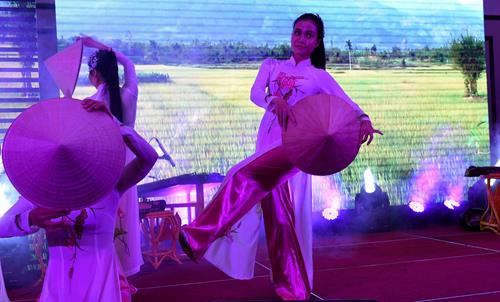  A dance by Vietnamese girls wearing ao dais (traditional long dresses) and conical hats