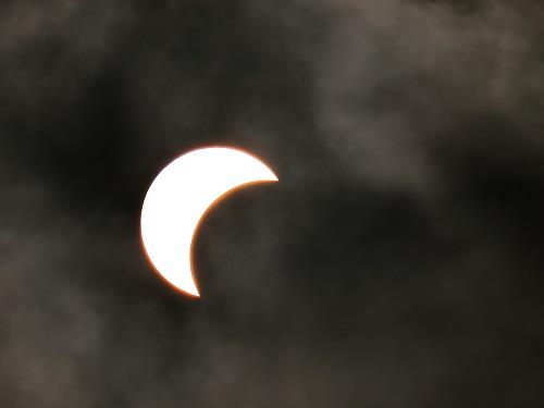 The partial solar eclipse is seen ‘retreating’ after reaching its peak in Ho Chi Minh City on March 9, 2016.