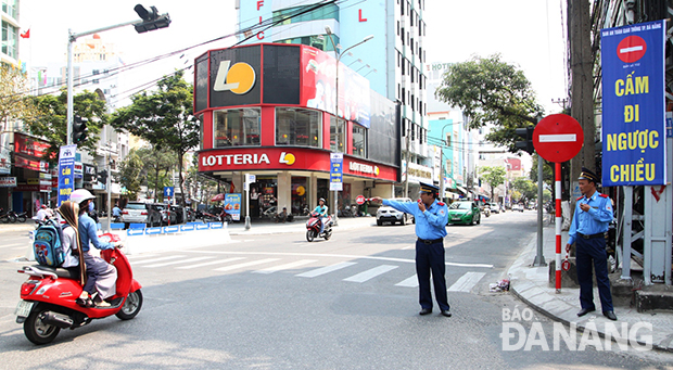 Hai thanh tra giao thông nhắc nhở, hướng dẫn việc cấm đi ngược chiều. Ảnh: HOÀNG HIỆP