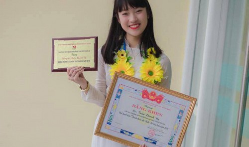 Tran Khanh Vy poses with a merit award honoring her as a typical young citizen in Nghe An Province, located in north-central Vietnam, in this photo provided by the schoolgirl.