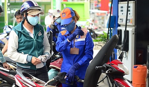 A woman refills her motorbike at a gasoline station in Ho Chi Minh City. Tuoi Tre