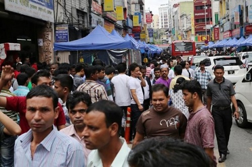 Foreign workers crowd the streets in Kuala Lumpur (Source: themalaymailonline.com)