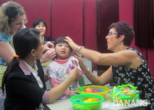 Phuong Thuy, a young girl from Cam Le District, wearing hearing aids