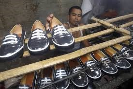 An employee works on shoes at a home shoe factory in Bogor, Indonesia (Source: www.wsj.com)