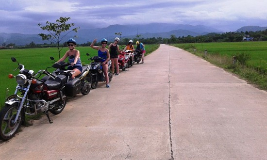 Delighted foreign trekkers pose for a photo during their ride. By courtesy of Do Van Thong