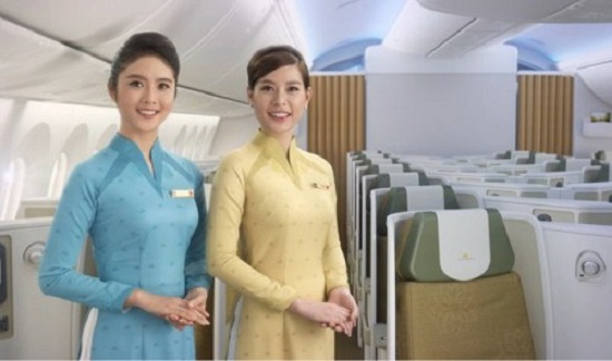 Two Vietnam Airlines flight attendants pose in an airplane in this undated handout photo provided by the carrier.