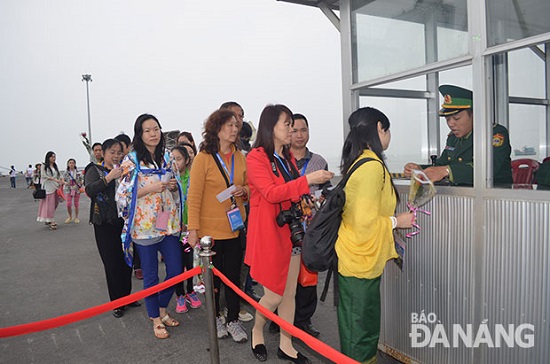 A local customs officer handling entry procedures for Chinese visitors