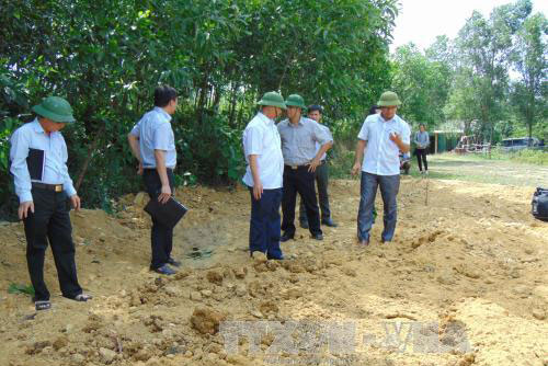 Sau khi lấy mẫu chất thải để đưa đi kiểm tra, lực lượng chức năng đã chỉ đạo tạm thời san lấp số chất thải này để khi có kết quả sẽ chỉ đạo xử lý. Ảnh: Phan Quân/TTXVN