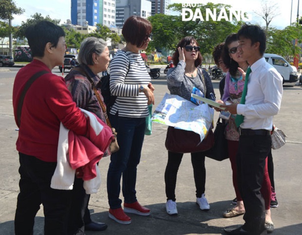 Some Chinese visitors on a local pavement 