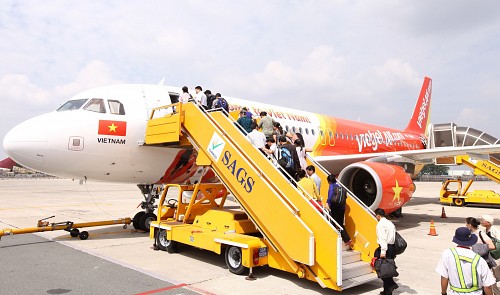 Passengers board a Vietjet aircraft at Tan Son Nhat International Airport in Ho Chi Minh City.