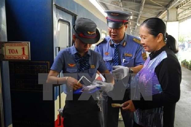 A railway employee checks a passenger’s ticket at Saigon Railway Station (Source: VNA)