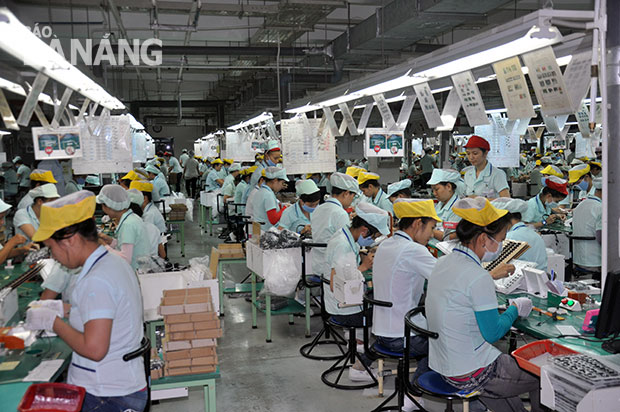 Workers at an electronic components factory in the city