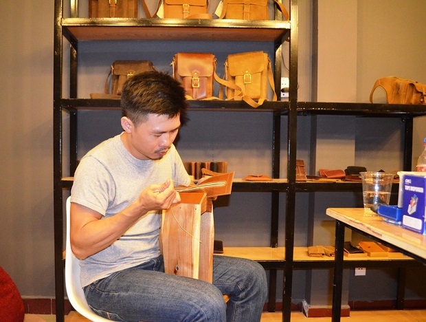 An Ton making a leather item