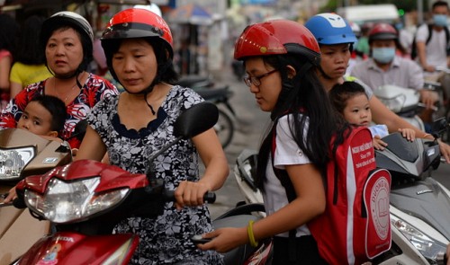 A schoolgirl and her mother outside of an English center in Phu Nhuan District, Ho Chi Minh City