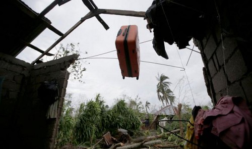 A suitcase hangs on the remains of the roof of a destroyed house by Hurricane Matthew in Les Cayes, Haiti, October 6, 2016.