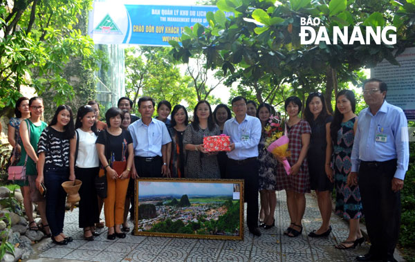 The 1-millionth visitor, Thai Thi Hoa Ly, with flowers in her hand