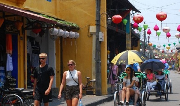 Foreign tourists walk at the Hoi An Ancient Town in Quang Nam Province, located in central Vietnam.