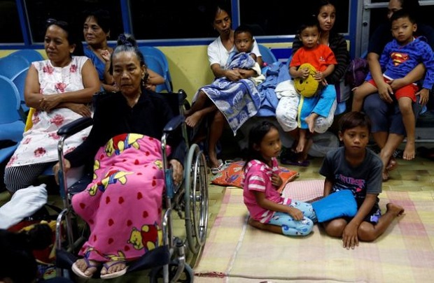 Residents driven from their homes by Super Typhoon Haima take shelter at an evacuation centre 